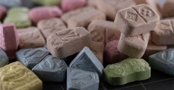 MDMA tablets and legal gavel, illustrating the legal status of MDMA in the UK and Europe as of 2026